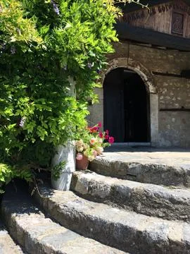 Close up of steps lined with flowers up to old church, Albania Balkans Stock Photos