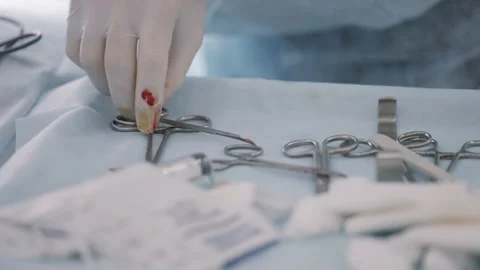 Close up of sterile surgical tools on a tray in the operating room. Action. Hand Stock Footage 148450797