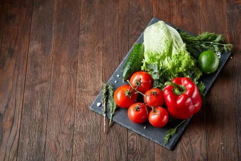 Close-up still life of assorted fresh vegetables and herbs on vintage wooden Stock Photos