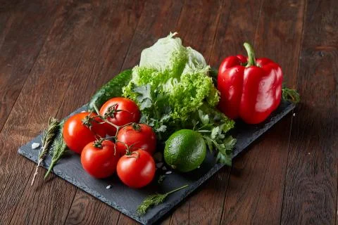Close-up still life of assorted fresh vegetables and herbs on vintage wooden Stock Photos