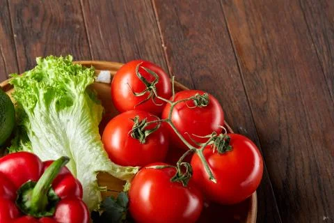 Close-up still life of assorted fresh vegetables and herbs on vintage wooden Stock Photos