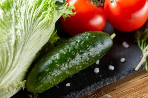 Close-up still life of assorted fresh vegetables and herbs on wooden rustic Stock Photos