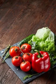 Close-up still life of assorted fresh vegetables and herbs on wooden rustic Stock Photos