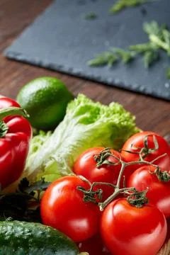 Close-up still life of assorted fresh vegetables and herbs on wooden rustic Stock Photos