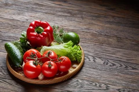 Close-up still life of assorted fresh vegetables and herbs on vintage wooden Stock Photos
