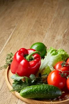 Close-up still life of assorted fresh vegetables and herbs on vintage wooden Stock Photos