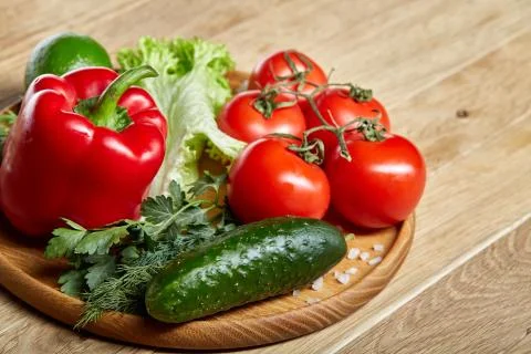 Close-up still life of assorted fresh vegetables and herbs on vintage wooden Stock Photos