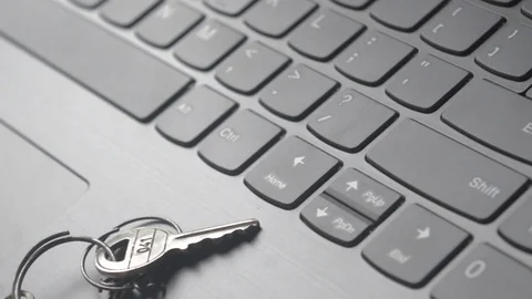 Close up of Still life of Key Ring on laptop computer keyboard. Conceptual im Stock Footage 128411429