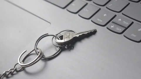 Close up of Still life of Key Ring on laptop computer keyboard. Conceptual im Stock Footage 128411437