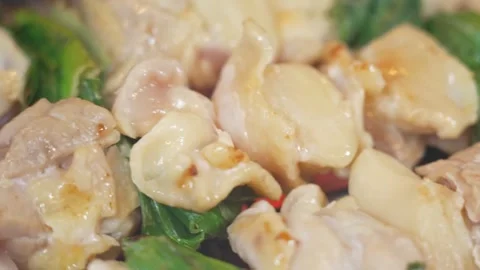 Close-up of Stir-Fried Chicken with Shrimp Paste and Green Vegetables in Wok Stock Footage 337440766