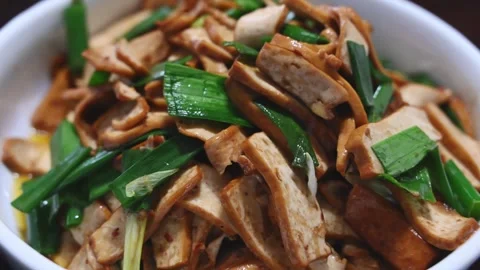 Close Up of Stir Fried Dried Tofu with Green Garlic Video stock 346488795