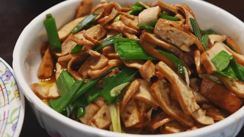 Close Up of Stir Fried Dried Tofu with Green Garlic Video stock 346488796