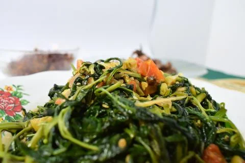 Close-up stir-fried spinach on white plate isolated white background Stock Photos