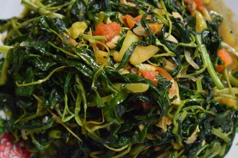 Close-up stir-fried spinach on white plate isolated white background Stock Photos