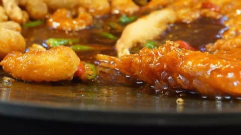 Close Up Stir-Frying Crispy Shrimp in Tangy Sweet and Sour Sauce Video stock 343027392