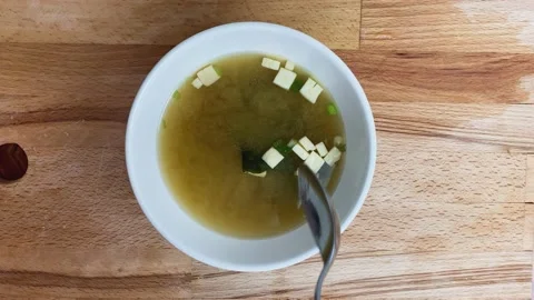 Close up of stirring bio Miso soup, tofu cheese, onion trampoline. Slow motion. Stock Footage 131562704