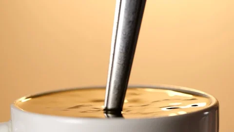 Close-up of Stirring black coffee with spoon in slow motion Stock-Footage 129649946