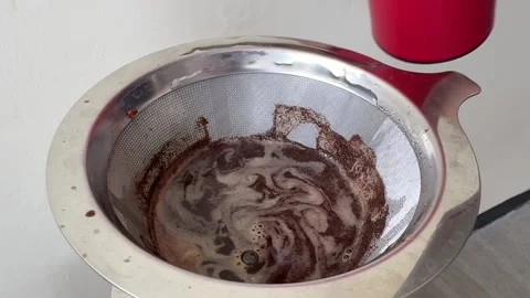 Close Up Of Stirring Dark Brown Coffee In A Metal Filter Stock Footage 313542597