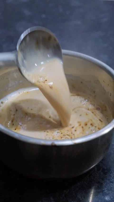 Close-up of Stirring Instant Coffee with Milk in a Stainless Steel Pot Vidéo 332887242