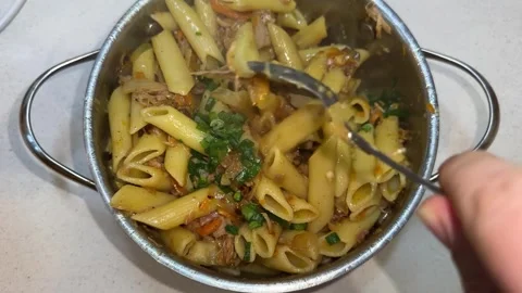 Close-up of Stirring Pasta Penne with Meat and Green Onions in a Pot Stock Footage 331811367