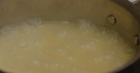 Close up stirring a pot of boiling rice Stock Footage 130688891