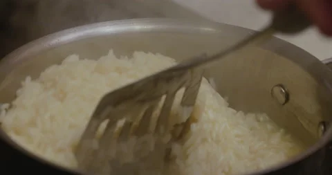 Close up stirring a pot of cooked rice Stock Footage 130688914