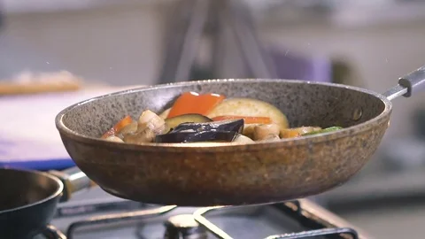 Close up of stirring vegetables on frying pan with oil. Slowly Video stock 72252234