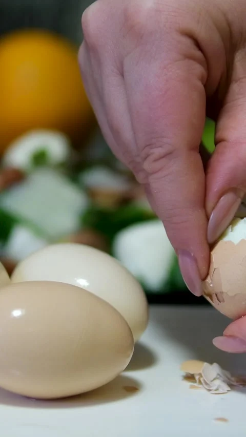 A close-up stock video featuring the hands of a woman delicately peeling a Video stock 313392738