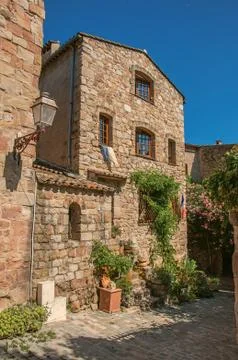 Close-up of stone house facade with bindweed in an alley at Les Arcs-sur-Argens. Stock Photos