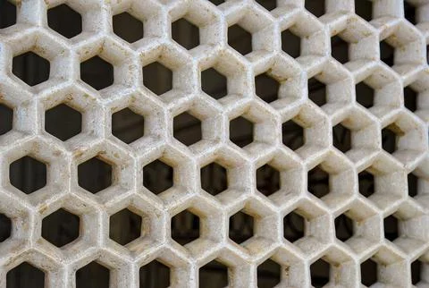 Close-up of a stone lattice with hexagonal openings Stock Photos