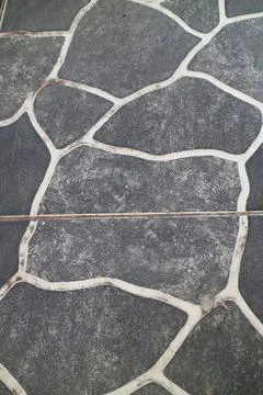 Close-up of stone pavement with irregular shapes and cracks Stock Photos