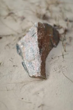 Close-up of a stone on a sandy shore Foto stock