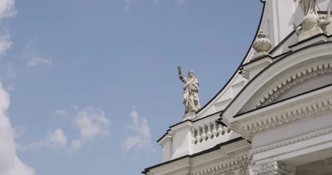 Close-up of stone statue on baroque basilica facade under a blue sky. Stock Footage 313834105