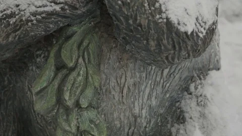 Close-up of a stone statue of panda covered with snow on a winter day Stock Footage 70345266