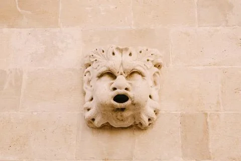Close-up stone statues, bas-reliefs and high reliefs on the walls of the old 스톡 사진