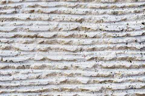 Close-up of stone surface with traces of processing. Parallel lines on the stone 库存照片
