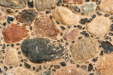 Close-up stone wall, cobblestone masonry, stone background, cobblestone pattern Stock Photos