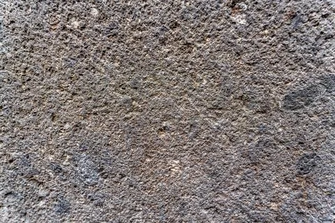 A close up of a stone wall with a rough texture Stock Photos