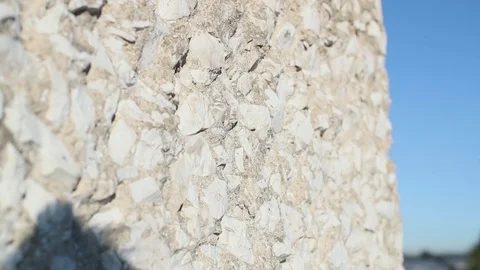 Close-up stone white wall against the background of the shore and red bridge Stock Footage 130116294
