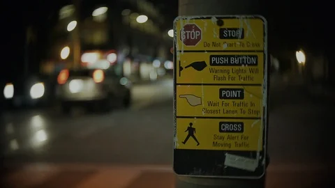 Close up of stoplight button instructions with cars passing by Video stock 104537121