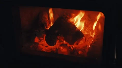 Close-up of a stove in a house with a fire burning in it. Video stock 320101764