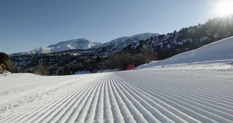 Close-up straight lines rows of freshly groomed ski slope in the morning Stock Footage 257364720