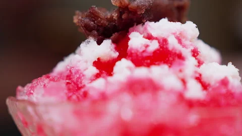 Close-up of strawberry-flavored shaved ice, piled high with fluffy texture and Stock Footage 314984495