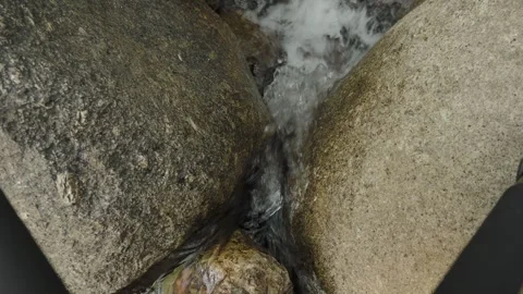 Close up stream of clear water on rocky bed. Loop. Stock Footage 332397452