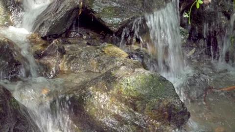 Close-up of a stream finding its way through a rocky stream bed Stock Footage 296367801