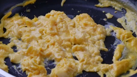 Close up stream from hot scramble egg in hot pan. Cooking food concept Stockbeeldmateriaal 232942592