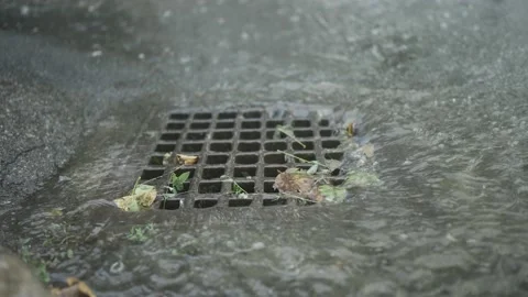 Close-up of stream of rainwater flows into the storm drain. Heavy torrential Stock Footage 204948883