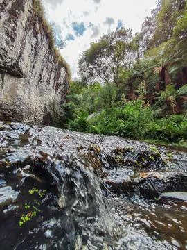 Close-up of a stream running in front of a wall Stock Photos