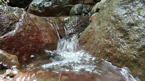 Close Up Stream Water Flowing Over Rocks in Forest – Detailed Footage Stock Footage 329778559
