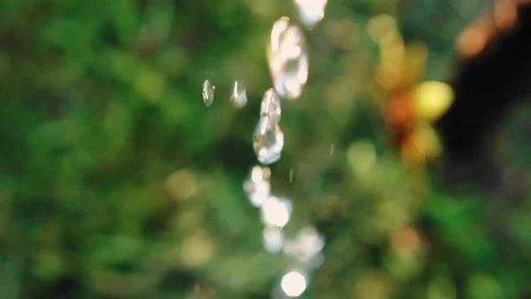 A close-up of a stream of water pouring from the red in the garden. Stock Footage 136099552